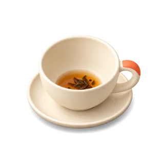 A cup of tea drunk down to a spoonful, with the leaves in it